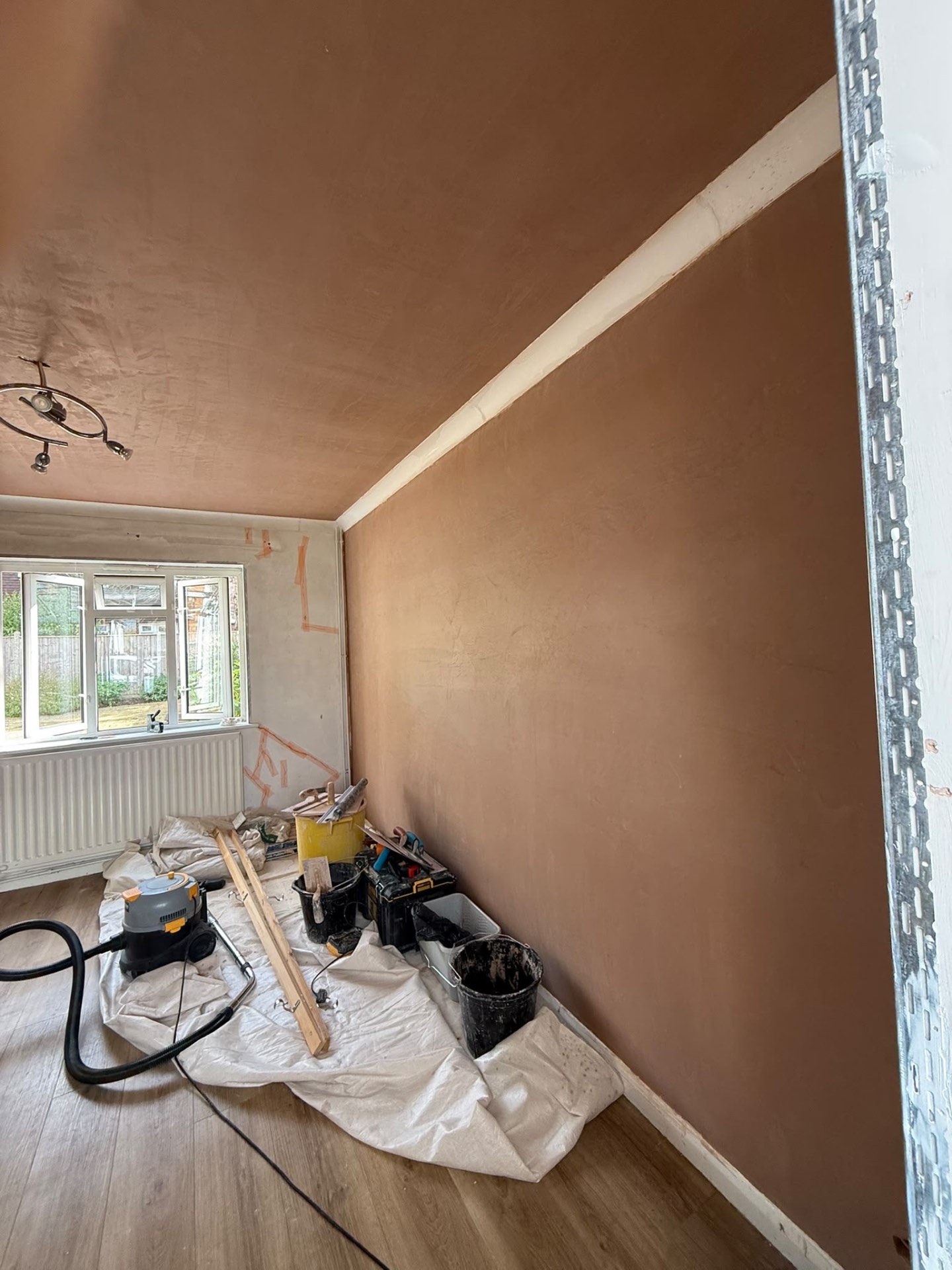 Fresh plaster finish meeting existing decorative coving