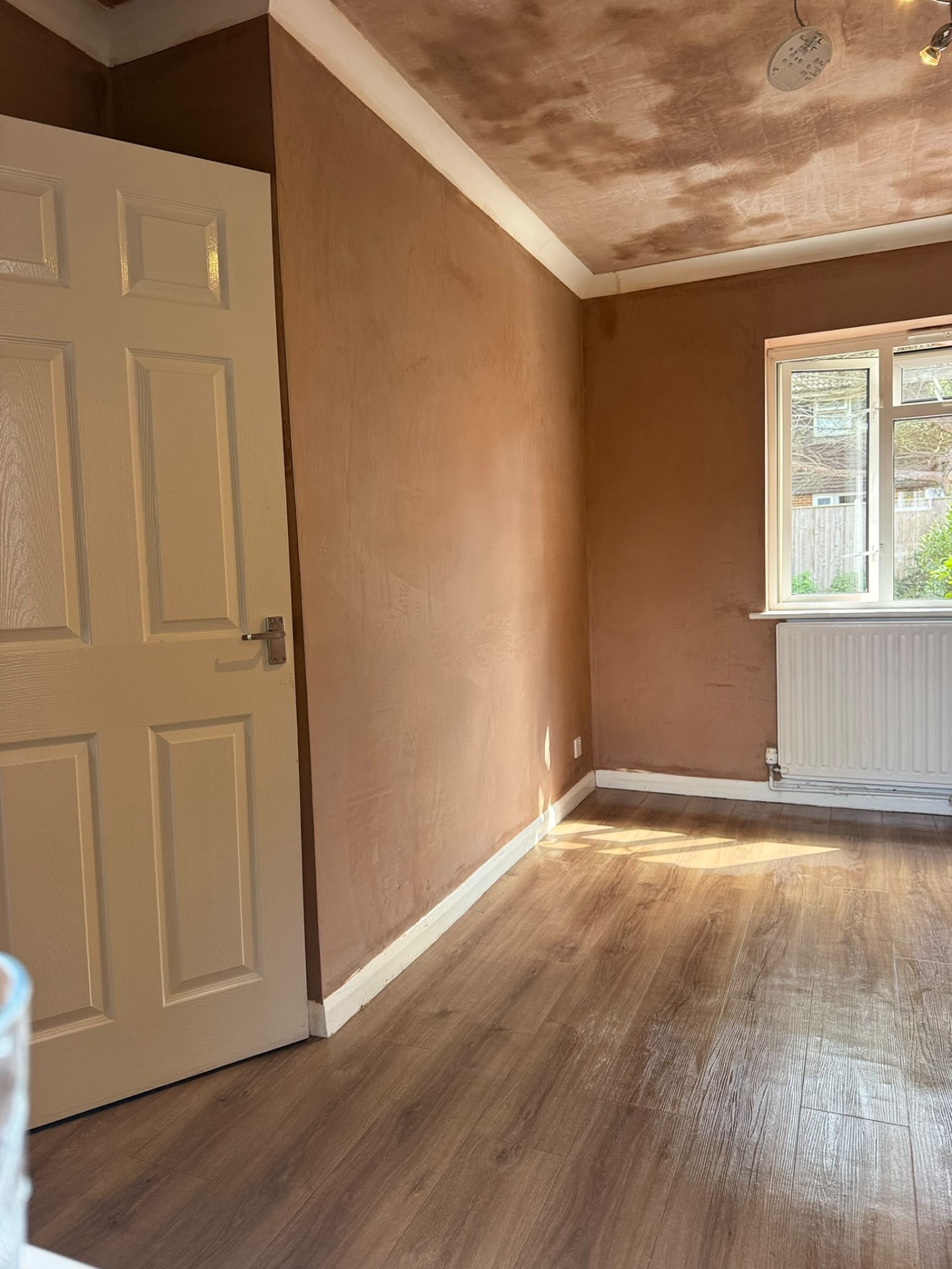 Freshly finished plaster walls and ceiling in a bedroom