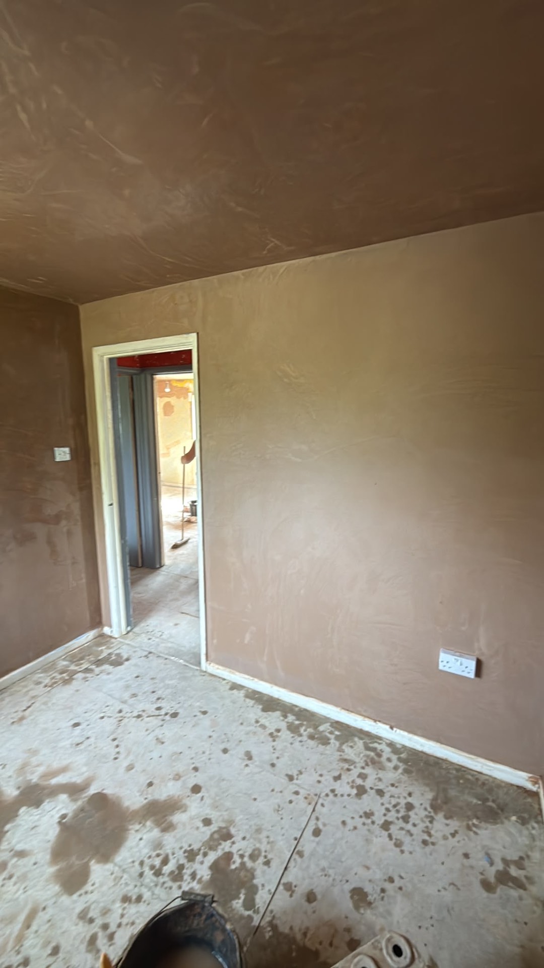 Fresh plaster across the walls of a residential room